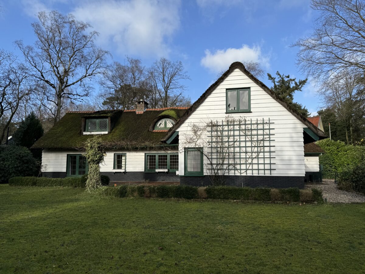 De oorspronkelijke woning met rieten kap vóór de nieuwbouw, villa in Huizen